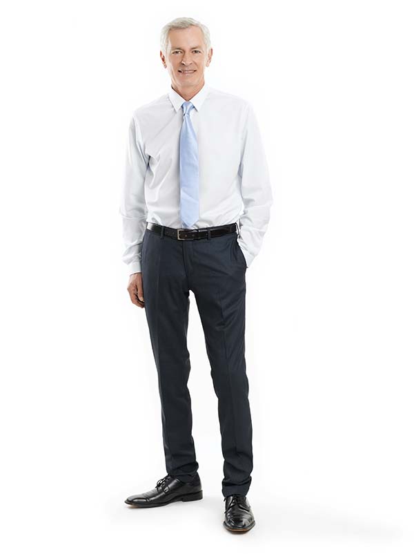 Full-length portrait of a senior businessman standing against white background.